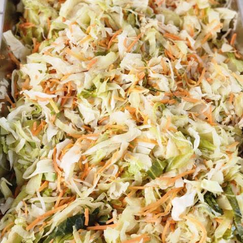 A full pan of steamed cabbage with carrot