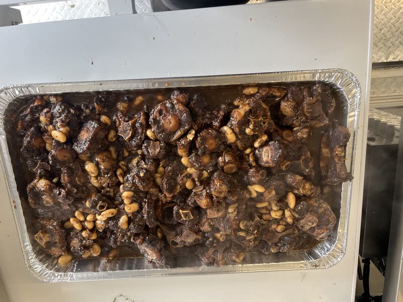 Oxtail with butter beans in a foil pan