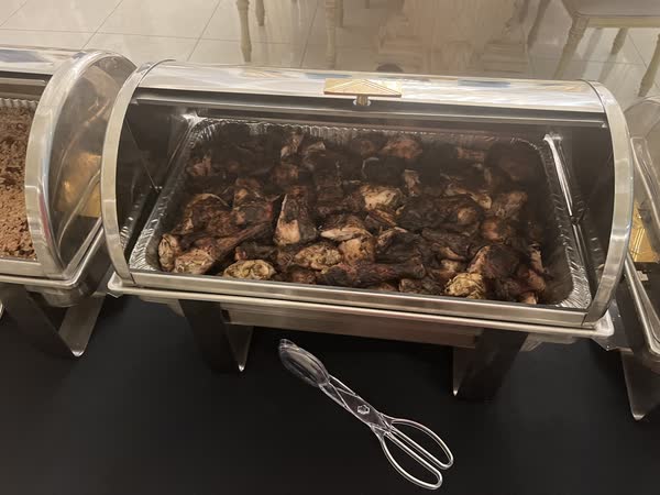 Browned chicken pieces in a roll-top warmer