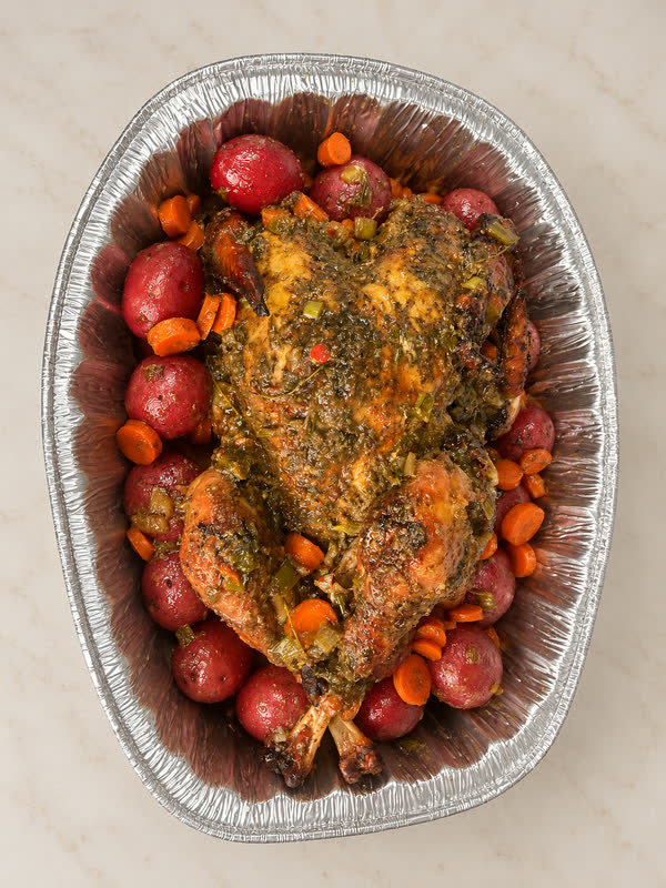 Jerk Turkey with potatoes and carrots in a foil tray